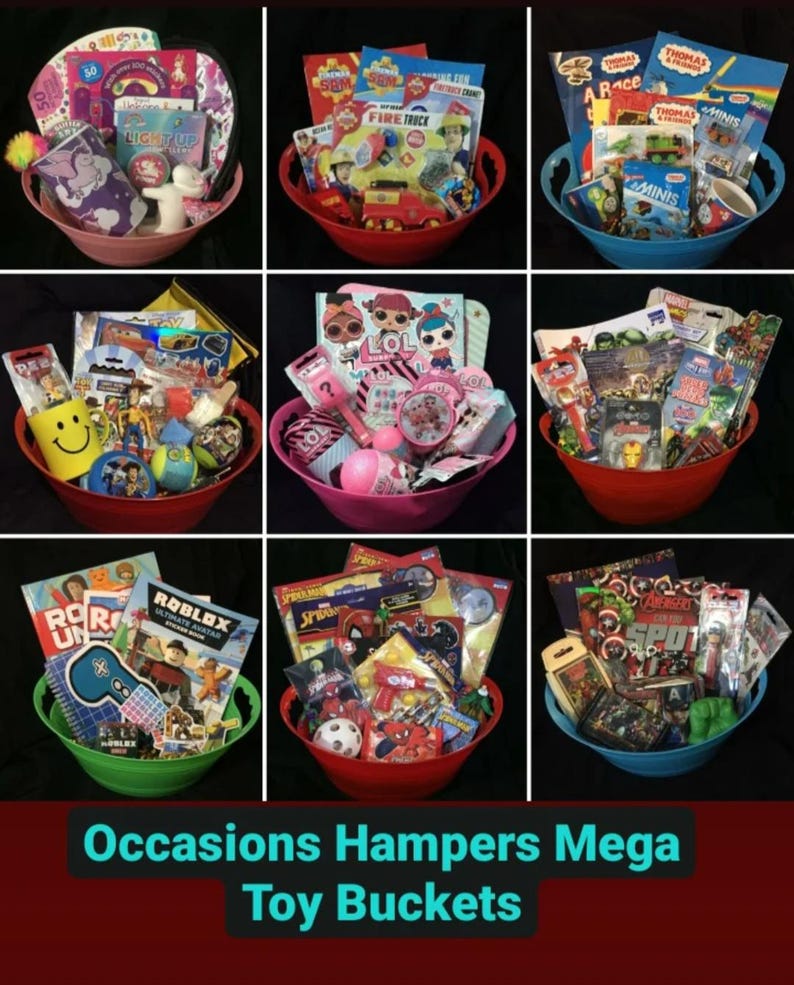May include: Nine colorful toy buckets filled with various toys and books. Each bucket is a different color, including pink, red, blue, and green. The text "Occasions Hampers Mega Toy Buckets" is at the bottom of the image.
