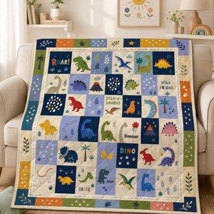 May include: A quilted blanket featuring a grid pattern of colorful dinosaur illustrations, palm trees, volcanoes, and text including ROAR!, WILD FRIEND, STEG-O-SAURUS, DINOSAUR, DINO, and BRAVE. The quilt has a cream border with green leaf motifs.