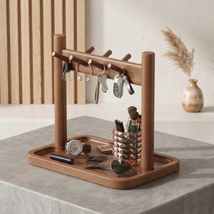 May include: A wooden key holder and organizer with a tray base. The key rack has pegs for keys and a tray for accessories like a watch, sunglasses, and a decorative container for makeup brushes. The wood has a warm, natural finish.