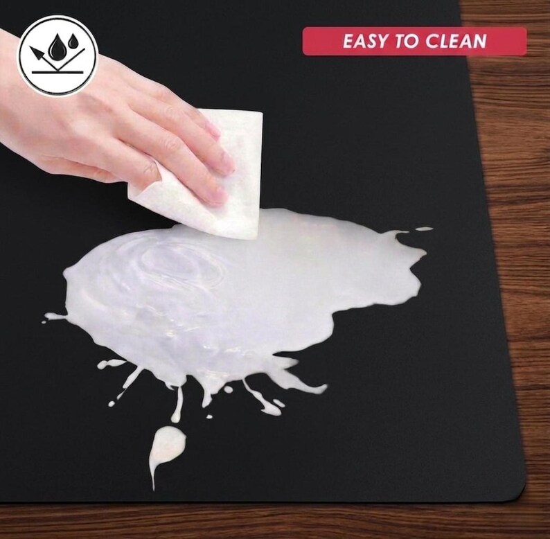 Easy-clean demonstration image showing liquid being wiped from the surface, emphasizing simple maintenance and practical everyday use.