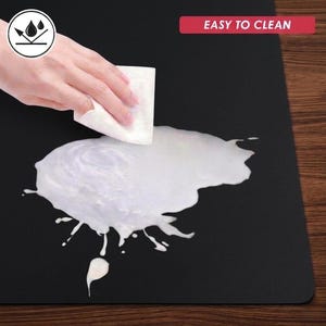 Cleaning demonstration image with liquid being wiped from the mat surface, emphasizing easy cleaning and simple daily care.