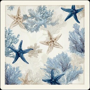 Close-up view of the white marine-themed mahjong mat, showcasing blue starfish, delicate coral patterns, and a clean framed border.