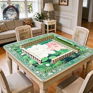 Oriental floral game mat shown in use with mahjong tiles, highlighting the spacious square playing area, smooth cushioned surface, and serene pond artwork with blooming lotus flowers, green lily pads, and decorative botanical border details for a refined tabletop presentation.