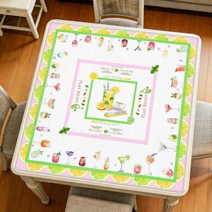 May include: Square table with a decorative overlay featuring a cocktail theme. The overlay has a pink and green border with lime slices. The center design includes cocktail illustrations and the text "Walls Left".