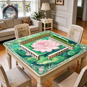 Oriental floral game mat shown in use with mahjong tiles, highlighting the spacious square playing area, smooth cushioned surface, and serene pond artwork with a central pink lotus blossom, flowing water details, green lily pads, and decorative botanical border elements for an elegant tabletop presentation.