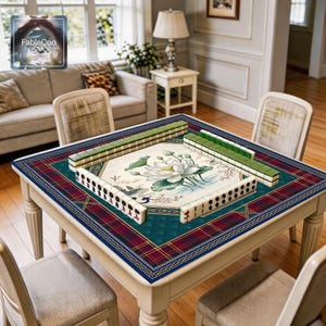 Oriental scenic game mat shown in use with mahjong tiles, highlighting the spacious square playing area, smooth cushioned surface, and refined artwork featuring lotus blossoms, layered leaves, traditional pavilion scenery, cloud details, and decorative framing in a rich navy, emerald green, wine red, gold, and cream palette.