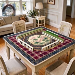 Oriental decorative game mat shown in use with mahjong tiles, highlighting the spacious square playing area, smooth cushioned surface, and refined central lotus artwork framed by geometric detailing, vintage plaid elements, and a luxurious burgundy, blue, green, gold, and cream color palette.