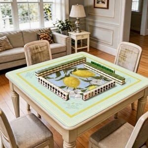 Mahjong mat shown in use with mahjong tiles placed around the center, highlighting the stylish citrus floral design and cozy home gaming atmosphere.