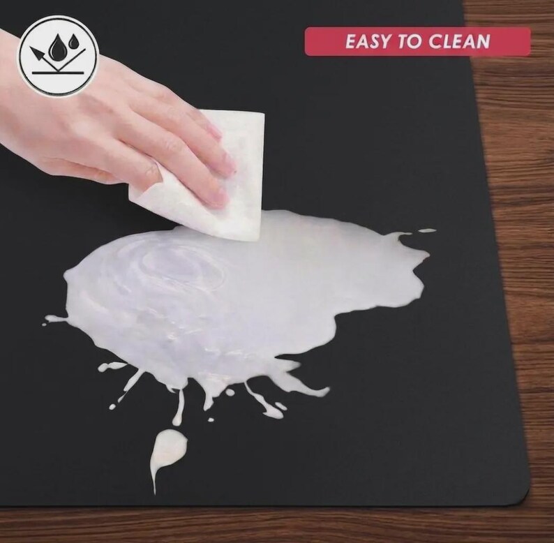 Easy-clean material demonstration showing liquid being wiped from the surface, emphasizing practical care and low-maintenance use.