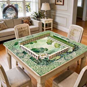 Lotus themed game mat shown in use with mahjong tiles, highlighting the spacious square playing area and the tranquil Chinese style artwork with soft green lotus leaves, flowing water details, and an intricate decorative frame.