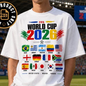 May include: A white short-sleeved t-shirt featuring the text FIFA WORLD CUP 2026 in bold black letters above the year 2026 in large colorful numbers. Below are fifteen national flags with country names and the text UNITED STATES MEXICO CANADA.