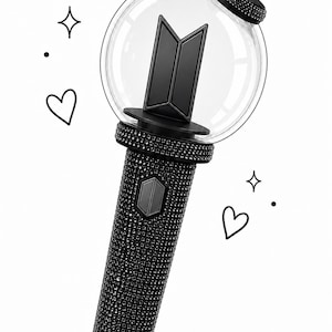 May include: A black and silver light stick with a clear orb at the top, featuring a black logo. The handle is covered in small, sparkling embellishments. Decorative hearts, stars, and dots are drawn around the light stick.