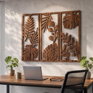 May include: A set of three rectangular wooden wall panels featuring intricate laser-cut designs of various tropical leaves, including monstera and fern foliage, arranged in a vertical orientation with a natural dark wood grain finish.