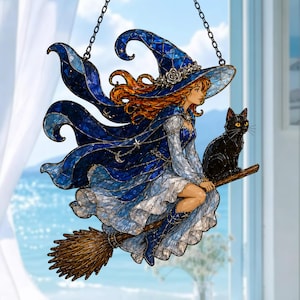 May include: A stained glass suncatcher depicting a witch with long orange hair wearing a blue hat and cape, riding a wooden broomstick with a black cat. The witch wears a white dress and blue boots, with silver star and moon accents on the cape.