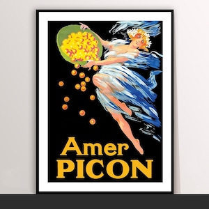 Puede incluir: Un póster publicitario vintage enmarcado de Amer Picon. El póster presenta a una mujer con tela azul y blanca fluida, sosteniendo un cuenco de orbes dorados. El texto "Amer Picon" es amarillo sobre un fondo negro.