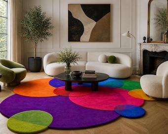 May include: A modern living room featuring a colorful, circular rug composed of overlapping circles in shades of purple, orange, red, green, and blue. The room includes a white sofa, armchairs, and a black coffee table, creating a vibrant and stylish interior.