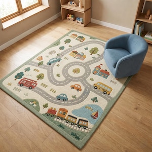 May include: A rectangular children's rug with a road map design. The rug features a cream-colored background with gray roads, green trees, and colorful illustrations of cars, a bus, a train, houses, and a lake with a sailboat. The rug is bordered with a green trim.