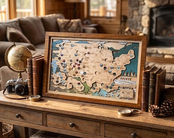 May include: A rectangular wooden wall map of the United States featuring layered cutouts, state borders, and various circular tokens placed across the map. The bottom right corner includes a small plaque with the text Travel Map and Lea & Luna.