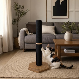 May include: A tall, cylindrical cat scratching post wrapped in black sisal rope, featuring a light wood accent ring in the centre and a sturdy, hexagonal wooden base. A calico cat is shown interacting with the post, clawing at the black texture.
