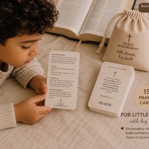 May include: A set of 15 prayer cards in a beige drawstring pouch with the text Peace in His Presence little hearts big faith. The cards feature religious text and a cross icon. One card is held up, showing sections titled Lets think about this, Lets talk, Lets Pray, and Lets do this together.