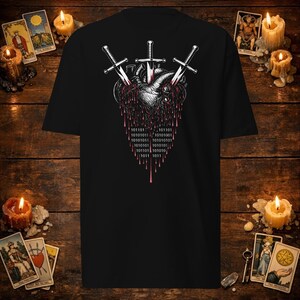 May include: A black t-shirt featuring a graphic of a human heart pierced by three silver swords. The heart is dripping red liquid that transitions into binary code consisting of ones and zeros. The design is centered on the front of the shirt.