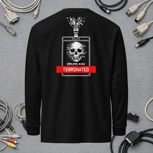 May include: A black long-sleeve shirt featuring a white graphic of an ID badge with a skull and the text "EMPLOYEE #404" above a red horizontal bar with the white text "TERMINATED". The design includes a digital glitch effect.