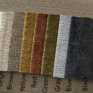 May include: A selection of fabric swatches in a range of colours: white, beige, brown, yellow, red, green, grey, blue, and black. The colour names are printed below each swatch. The fabric has a textured weave.