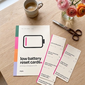 May include: A set of low battery reset cards featuring a battery icon and text including 'low battery reset cards' and 'for the house, on the days you're at 4%'. The cards list tasks like 'put one thing back' and 'make the bed'.