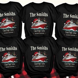Puede incluir: Seis camisetas negras de manga corta con un gr&aacute;fico de un crucero rojo y blanco con un gorro de Pap&aacute; Noel y el a&ntilde;o 2026. El texto dice The Smiths, Christmas Crew y Holiday Location, rodeado de adornos navide&ntilde;os colgantes.