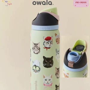 May include: A light green Owala water bottle featuring a pattern of various cats, including one wearing a red beret and another with a pink bow. The bottle has a black lid with a light blue band and a light green flip-top spout mechanism.