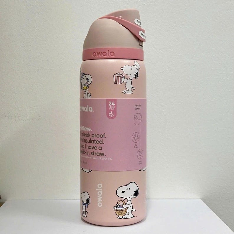 May include: A pink Owala water bottle featuring Snoopy illustrations. The bottle has a flip-top lid and a built-in straw. The bottle is leak-proof and insulated, with a capacity to keep drinks cold for 24 hours.