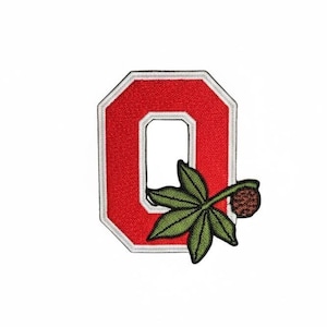 May include: An embroidered patch featuring a bold red block letter O with a white border. Overlaid on the lower right side of the letter is a green buckeye leaf cluster with a small brown textured buckeye nut attached to a thin stem.