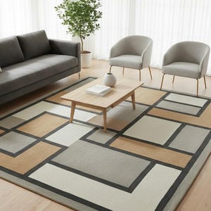 Op de afbeelding: Een moderne woonkameropstelling met een grijze bank, twee grijze fauteuils en een houten salontafel. Een geometrisch patroon tapijt in neutrale tinten beige, grijs en wit vormt de basis van de ruimte. Een kleine bijzettafel en een potplant maken de scène compleet.