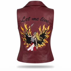 May include: A sleeveless burgundy vest featuring a back embroidery of a warrior figure with long blonde hair, black wings, and a spear, surrounded by yellow and orange flames. The text "Let me live" is embroidered in black above the figure.