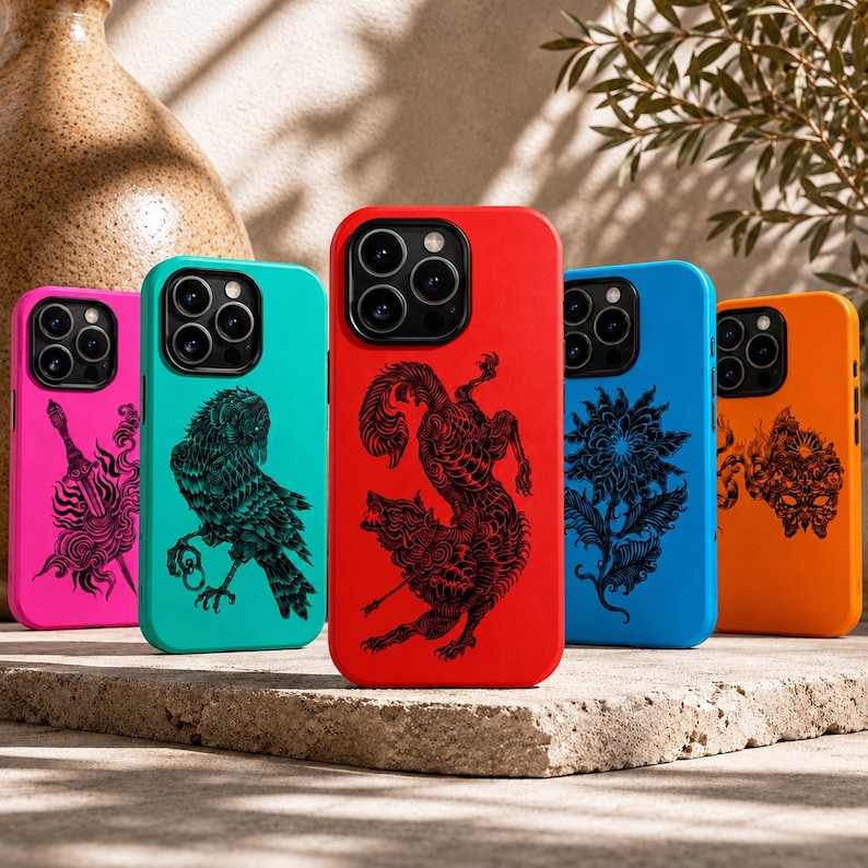 May include: A selection of brightly coloured phone cases. Each case has a unique black graphic design on a vibrant background. Colours include pink, teal, red, blue, and orange. The designs include an owl, a wolf, and floral patterns.