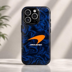 May include: A black smartphone case with a blue and black swirled pattern and an orange McLaren logo. The case has a glossy finish and a raised edge around the camera lenses.