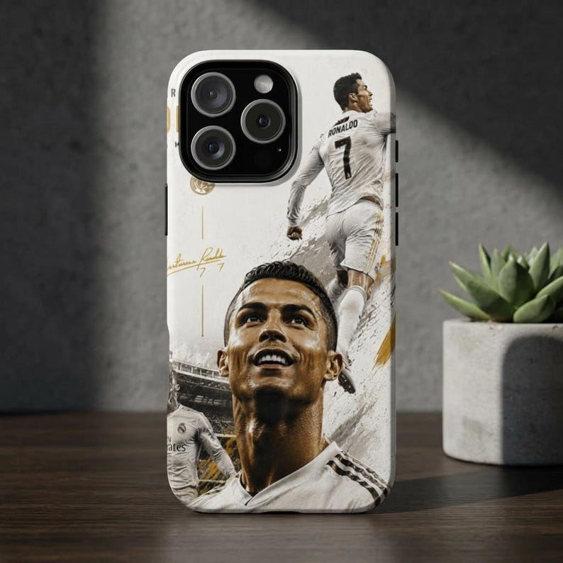 May include: White phone case featuring a collage of Cristiano Ronaldo in a soccer uniform. The design includes images of Ronaldo in action, his signature, and the number 7. The case has a glossy finish.