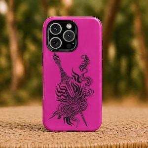 May include: A magenta phone case with a black illustration of a sword and flame-like swirls. The case has a glossy finish and a camera module with three lenses. The phone case is resting on a woven surface.