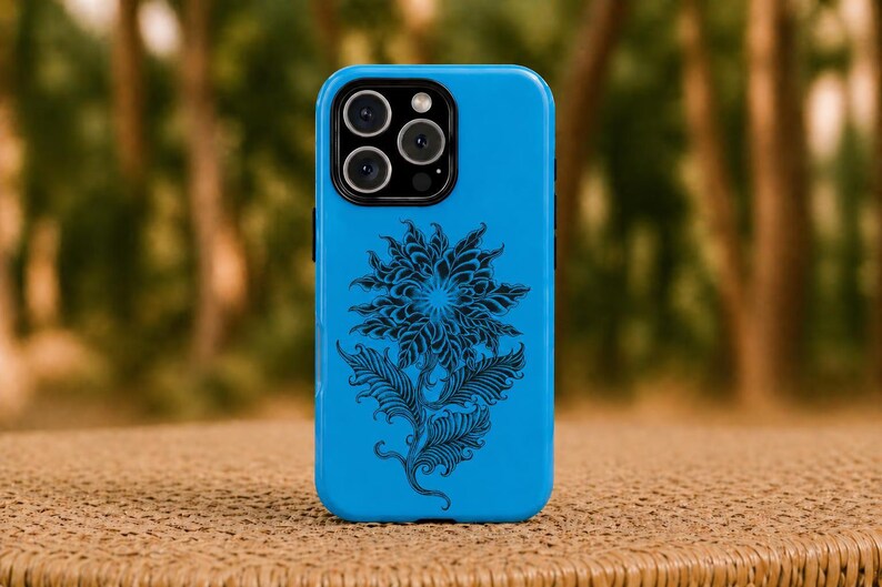 May include: A vibrant blue phone case with a black floral pattern. The case has a shiny surface and a camera aperture with several lenses. The floral design includes a large flower and leaves.