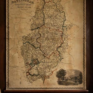 May include: A large, vintage-style wall map titled Poor Law Union Parish Map of the County of Nottingham, featuring detailed railway systems, geographical boundaries, and a small landscape illustration in the bottom right corner, all printed on aged, sepia-toned paper.