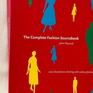 May include: The Complete Fashion Sourcebook by John Peacock, a red book cover with colorful silhouettes of people wearing different styles of clothing. The text on the cover reads "2000 illustrations charting 20th-century fashion".