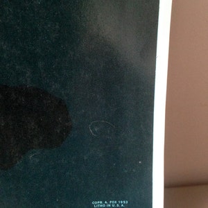May include: A dark green poster with black text that reads "COPR. A. FOX 1953 LITHO IN U.S.A."