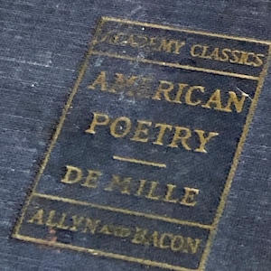 May include: A gold-colored book cover with the text "Academy Classics American Poetry De Mille Allyn and Bacon".
