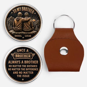 May include: Two circular metal coins with bronze-toned relief designs and a brown leather keychain holder. One coin shows two people sitting with the text TO MY BROTHER DANIEL LUCAS. The other coin features the text ONCE A BROTHER ALWAYS A BROTHER.