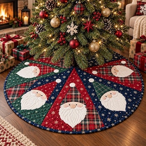 May include: A circular quilted Christmas tree skirt featuring a patchwork design of red and green plaid fabric alternating with dark blue panels decorated with white snowflakes. The skirt displays multiple appliqued Santa Claus faces.