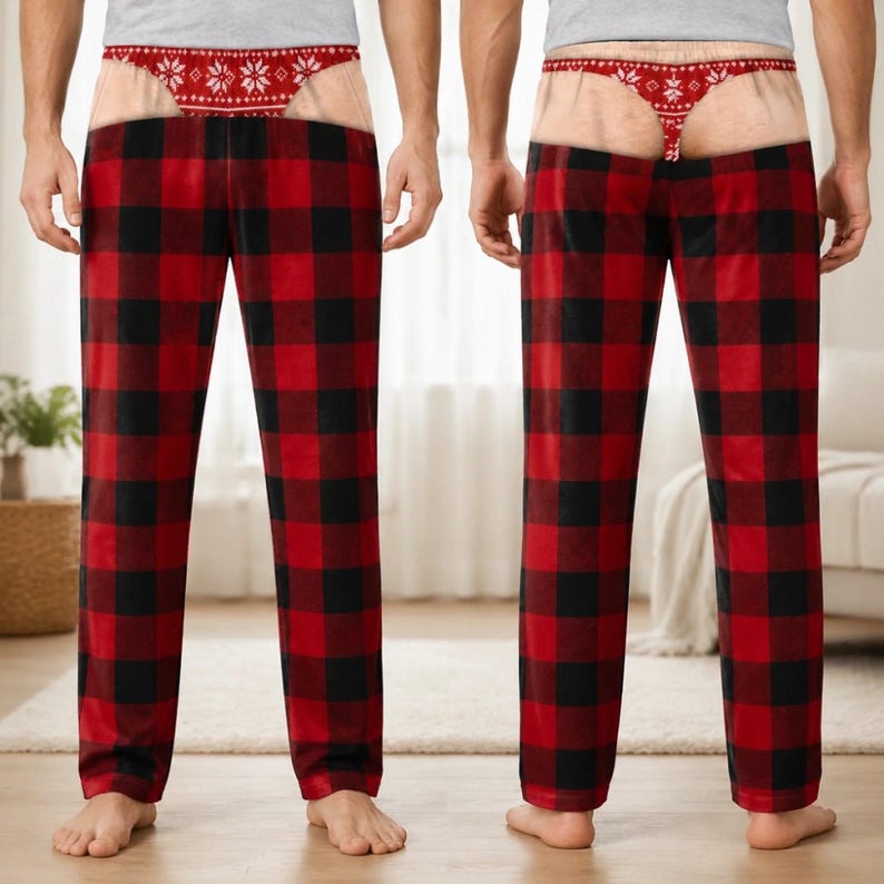 May include: A pair of lounge trousers featuring a red and black buffalo check pattern. The waistband area displays a printed graphic of a red and white snowflake-patterned thong over a skin-toned background, creating a humorous trompe l'oeil effect.