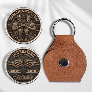 May include: Two circular metal coins featuring skeleton figures in cowboy hats clinking beer mugs with the text OLD BASTARDS BROTHER CLUB, LIFETIME MEMBER, JEFFREY, AUSTIN, and NO RULES. JUST BROTHERS, alongside a brown leather keychain with a silver ring.