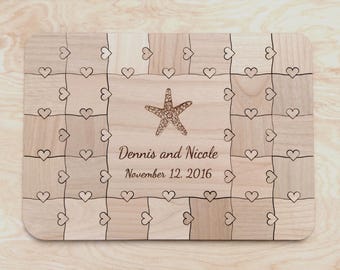 May include: A rectangular wooden puzzle board featuring a laser-engraved starfish at the center, surrounded by a grid of interlocking heart-shaped patterns. The text Dennis and Nicole and November 12, 2016 is engraved below the starfish.