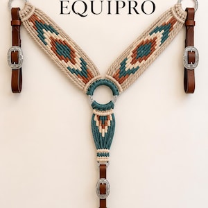 May include: A macrame horse breast collar featuring the text EQUIPRO, crafted with beige, teal, and rust-coloured cord. It includes brown leather straps, silver-toned metal rings, and ornate silver buckles at the connection points.