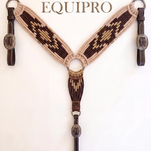 May include: A breast collar for a horse featuring a macrame design in beige and dark brown with a geometric pattern. The piece includes dark brown leather straps with ornate metal buckles and rings. The text EQUIPRO is centered above the item.